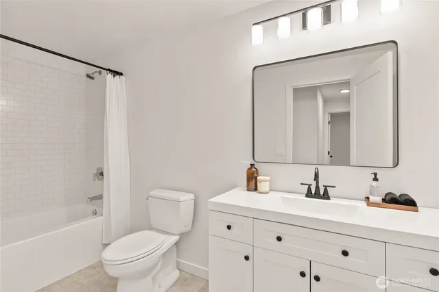 a white bath tub sitting next to a white toilet