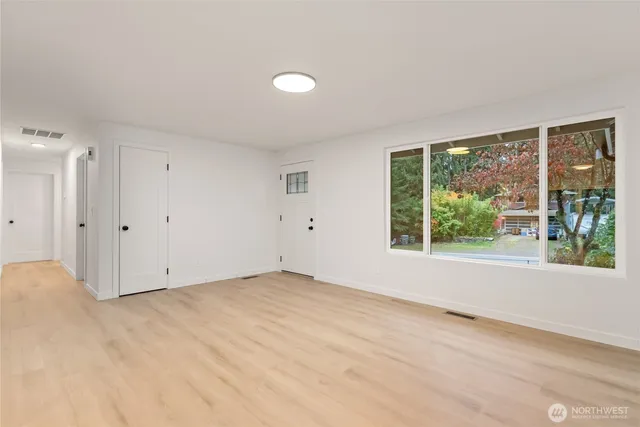 a view of an empty room with glass door