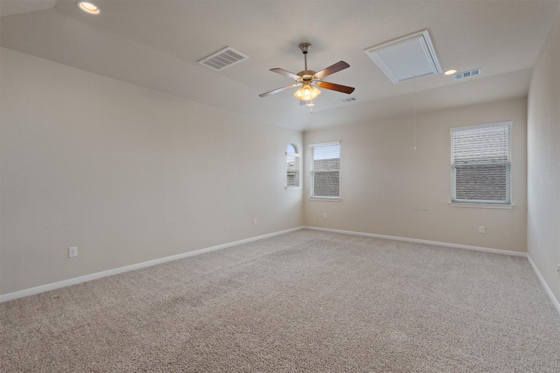533 Jess Maynard Trail Leander, TX 78641 - Photo 17 of 24 Unfurnished room with attic access, light carpet, and ceiling fan