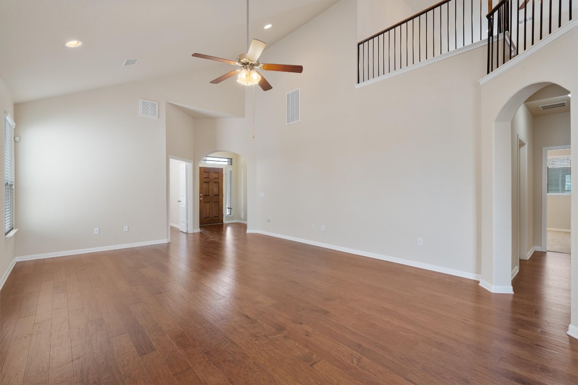 533 Jess Maynard Trail Leander, TX 78641 - Photo 4 of 24 Spare room with arched walkways, hardwood / wood-style flooring, high vaulted ceiling, recessed lighting, and a ceiling fan
