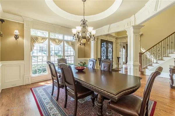 a dining room with furniture a chandelier and window