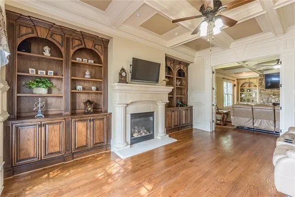 a living room with furniture fireplace and flat screen tv