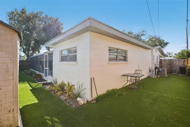a backyard of a house with table and chairs