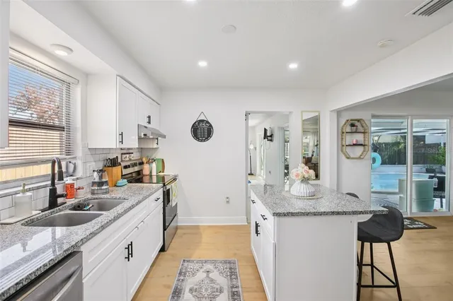 a kitchen with a sink and cabinets