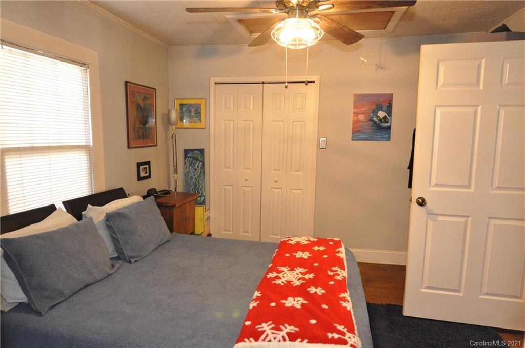106 Nella Street Chester, SC 29706 - Photo 11 of 13 a bedroom with a bed and a chandelier