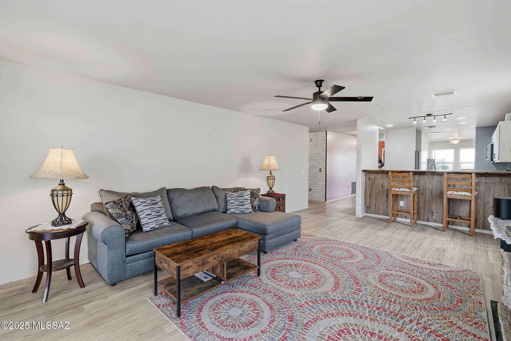 1458 North Wentworth Road Vail, AZ 85641 - Photo 35 of 44 a living room with furniture and a chandelier