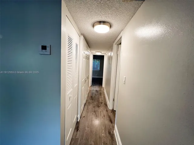 a view of hallway with wooden floor