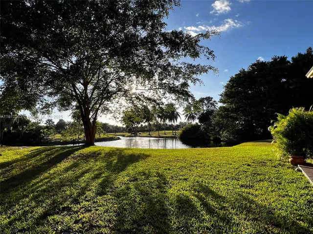 a view of backyard with swimming pool