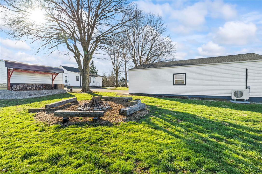 10797 Gratis Jacksonburg Road Somerville, OH 45064 - Photo 26 of 27 This spacious yard features a cozy fire pit area, perfect for outdoor gatherings.