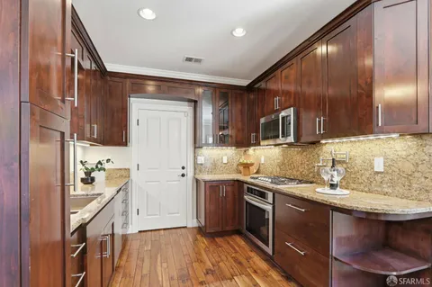 a kitchen with a sink a stove and cabinets