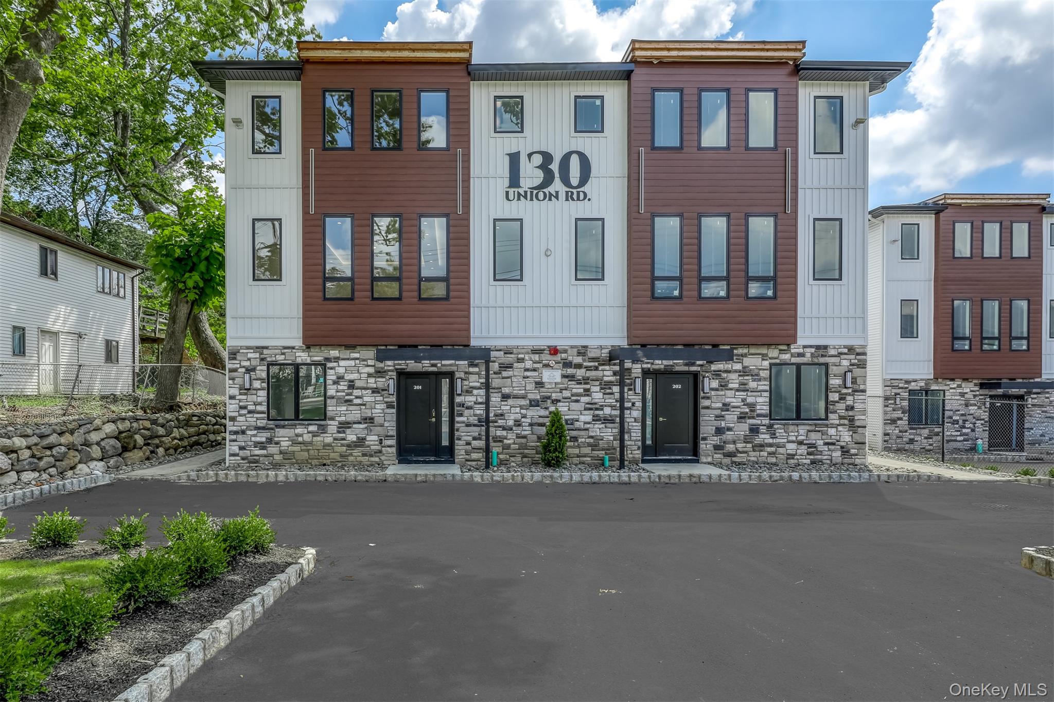 130 Union Road, Unit 201 Spring Valley, NY 10977 - Photo 3 of 47 a front view of a house with a garden