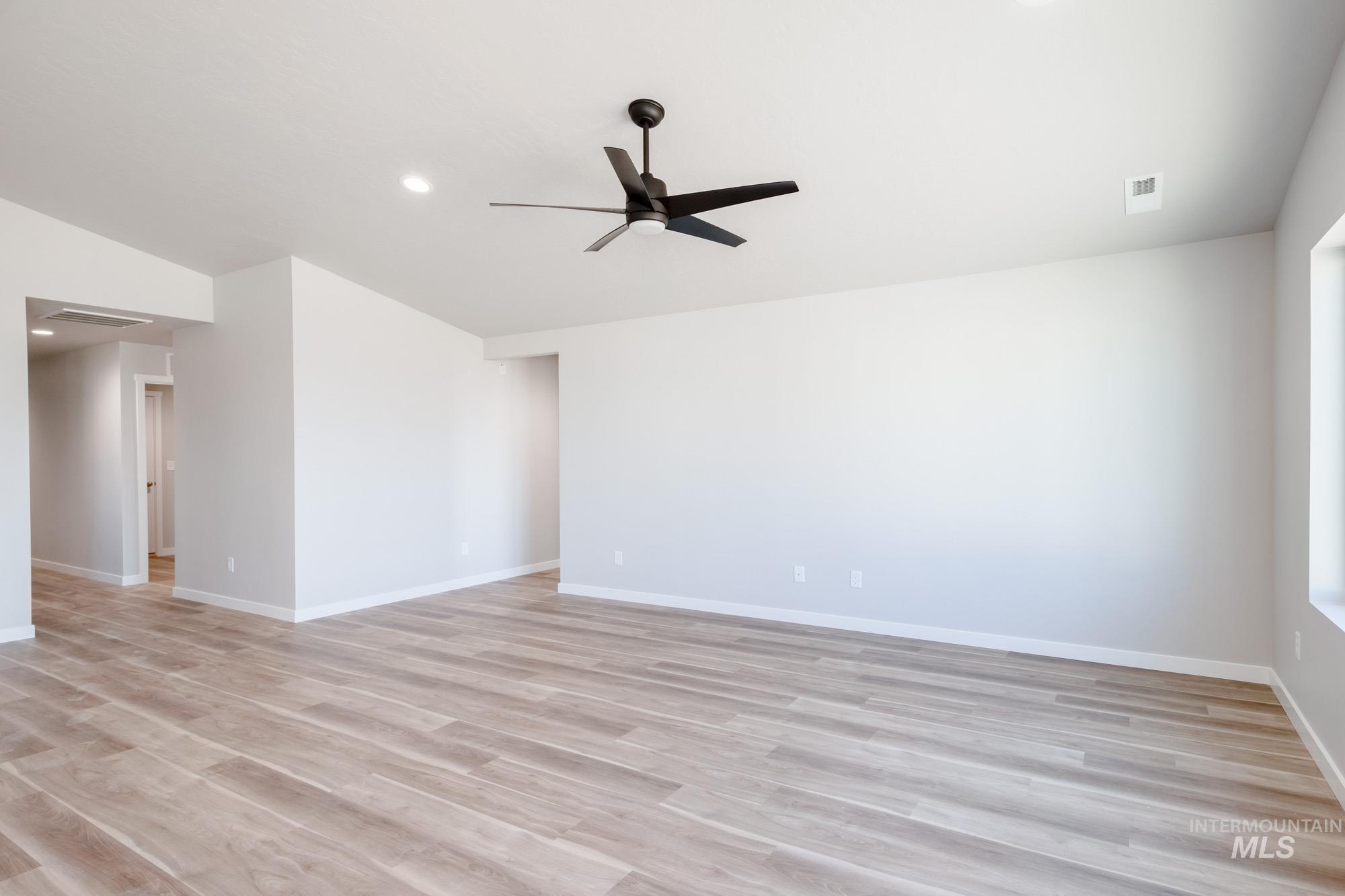 7256 South Menzingers Avenue Meridian, ID 83642 - Photo 12 of 23 Spare room with ceiling fan, light wood-style floors, and recessed lighting