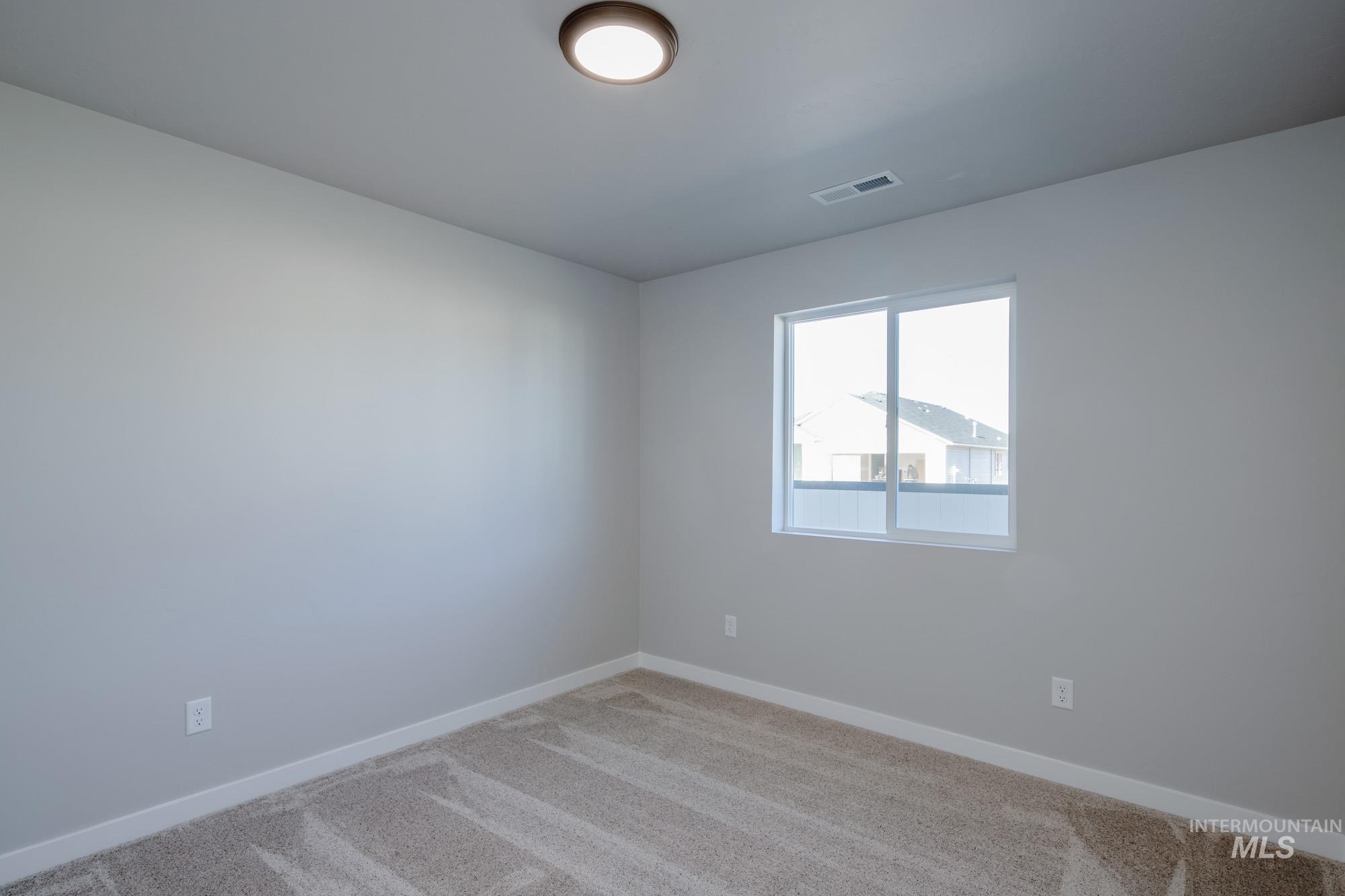7256 South Menzingers Avenue Meridian, ID 83642 - Photo 14 of 23 Carpeted spare room with baseboards