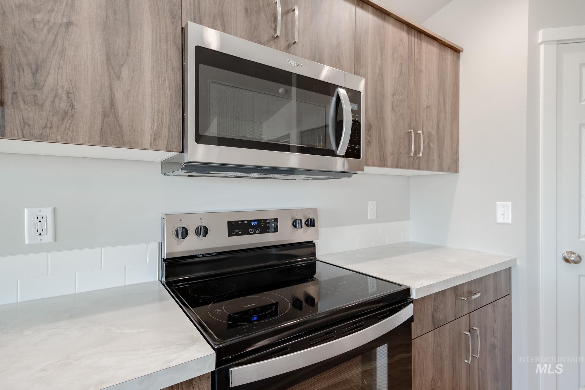 7256 South Menzingers Avenue Meridian, ID 83642 - Photo 5 of 23 Kitchen featuring appliances with stainless steel finishes, modern cabinets, and light countertops