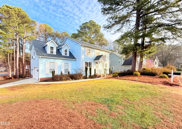 a view of a house with a yard and garage