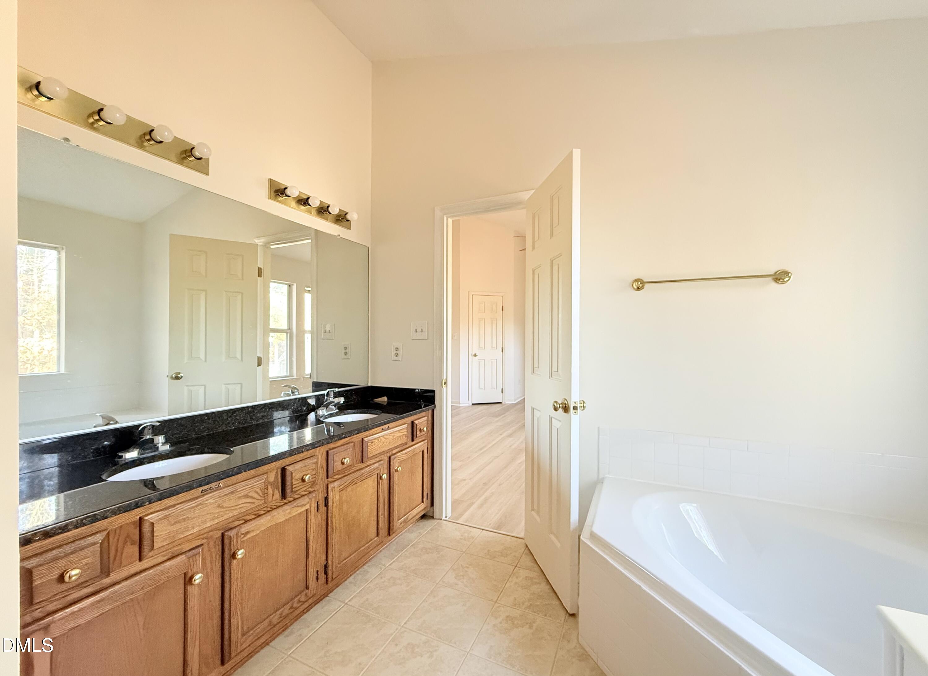 3610 Long Ridge Road Durham, NC 27703 - Photo 13 of 21 a spacious bathroom with a granite countertop tub sink and mirror