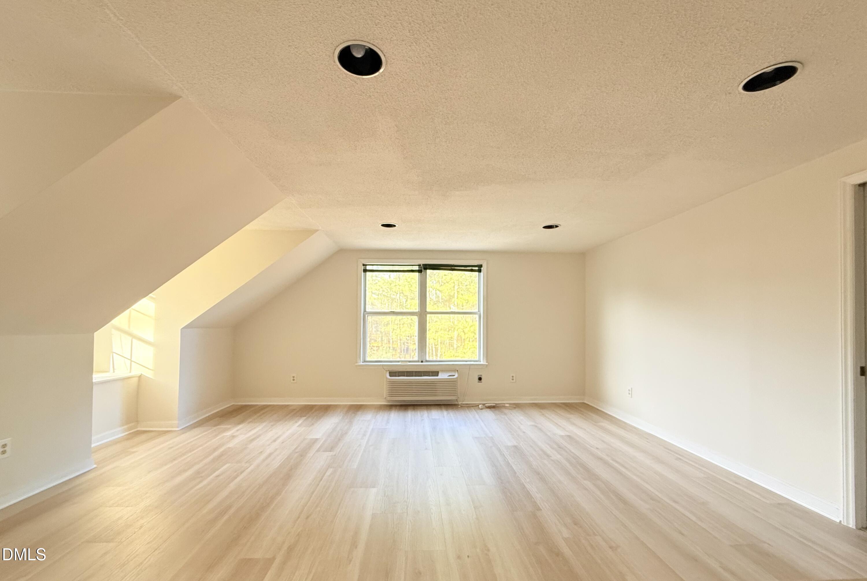 3610 Long Ridge Road Durham, NC 27703 - Photo 15 of 21 an empty room with wooden floor and windows