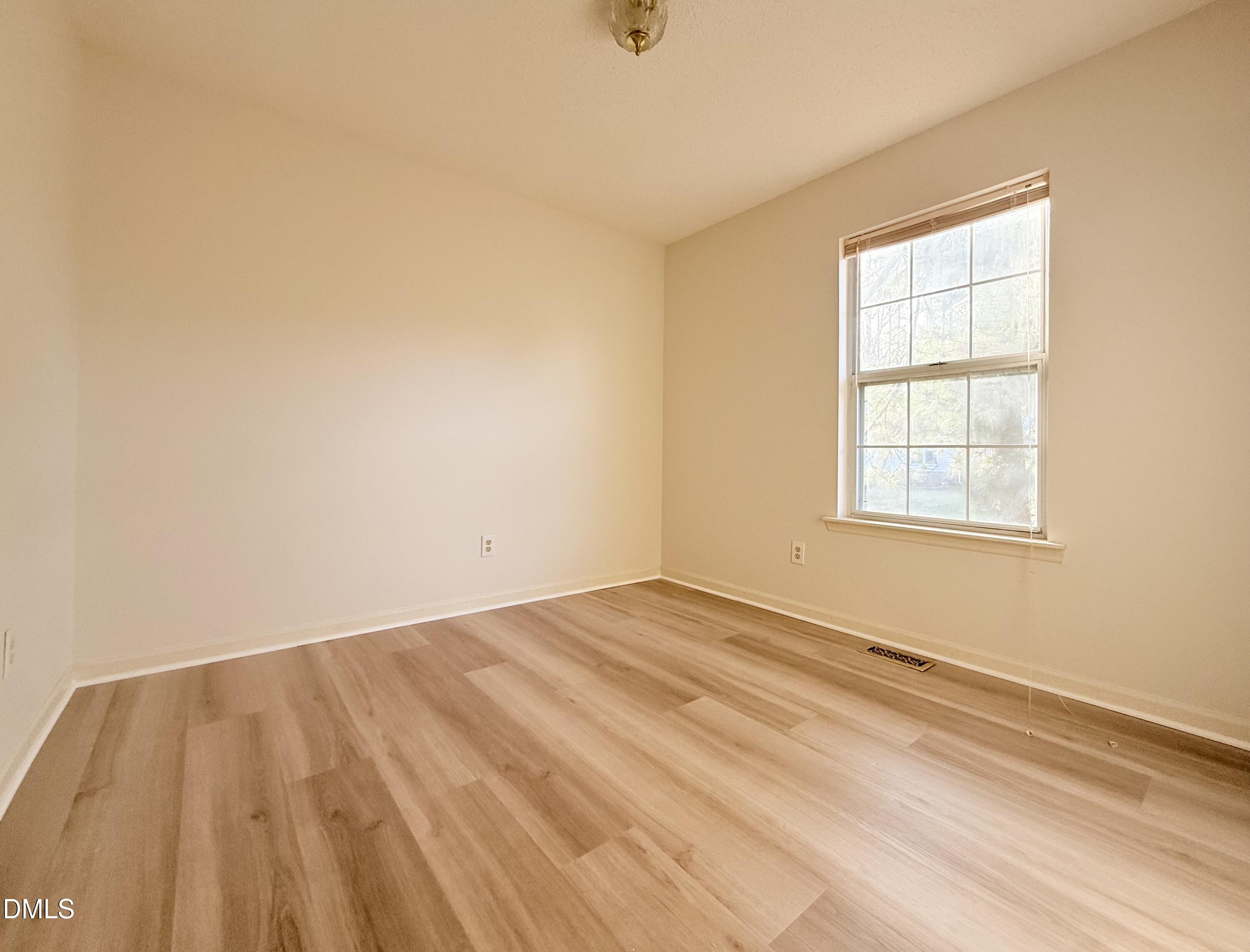 3610 Long Ridge Road Durham, NC 27703 - Photo 16 of 21 a view of an empty room with wooden floor and a window