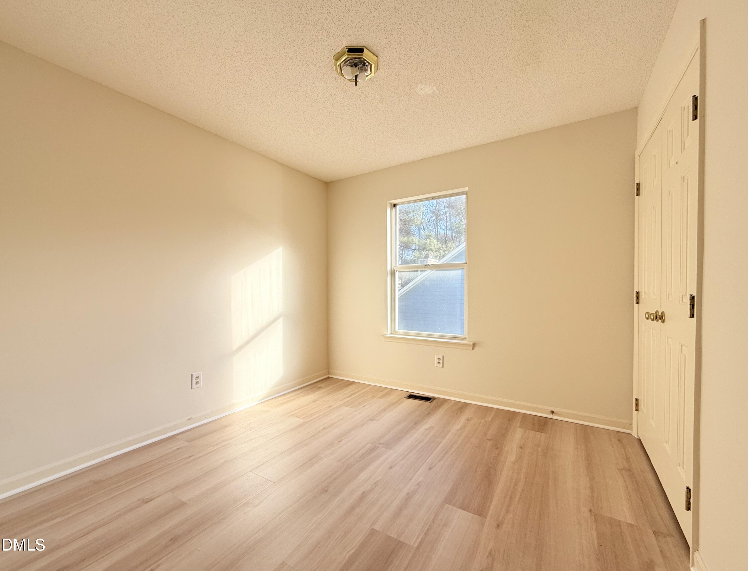 3610 Long Ridge Road Durham, NC 27703 - Photo 17 of 21 an empty room with wooden floor and windows