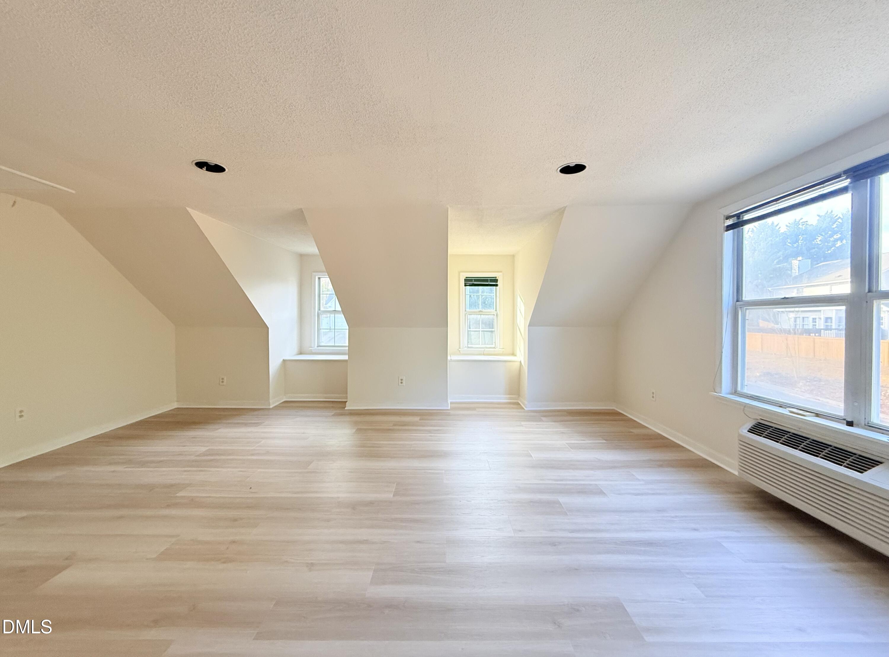3610 Long Ridge Road Durham, NC 27703 - Photo 18 of 21 a view of an empty room with window and wooden floor