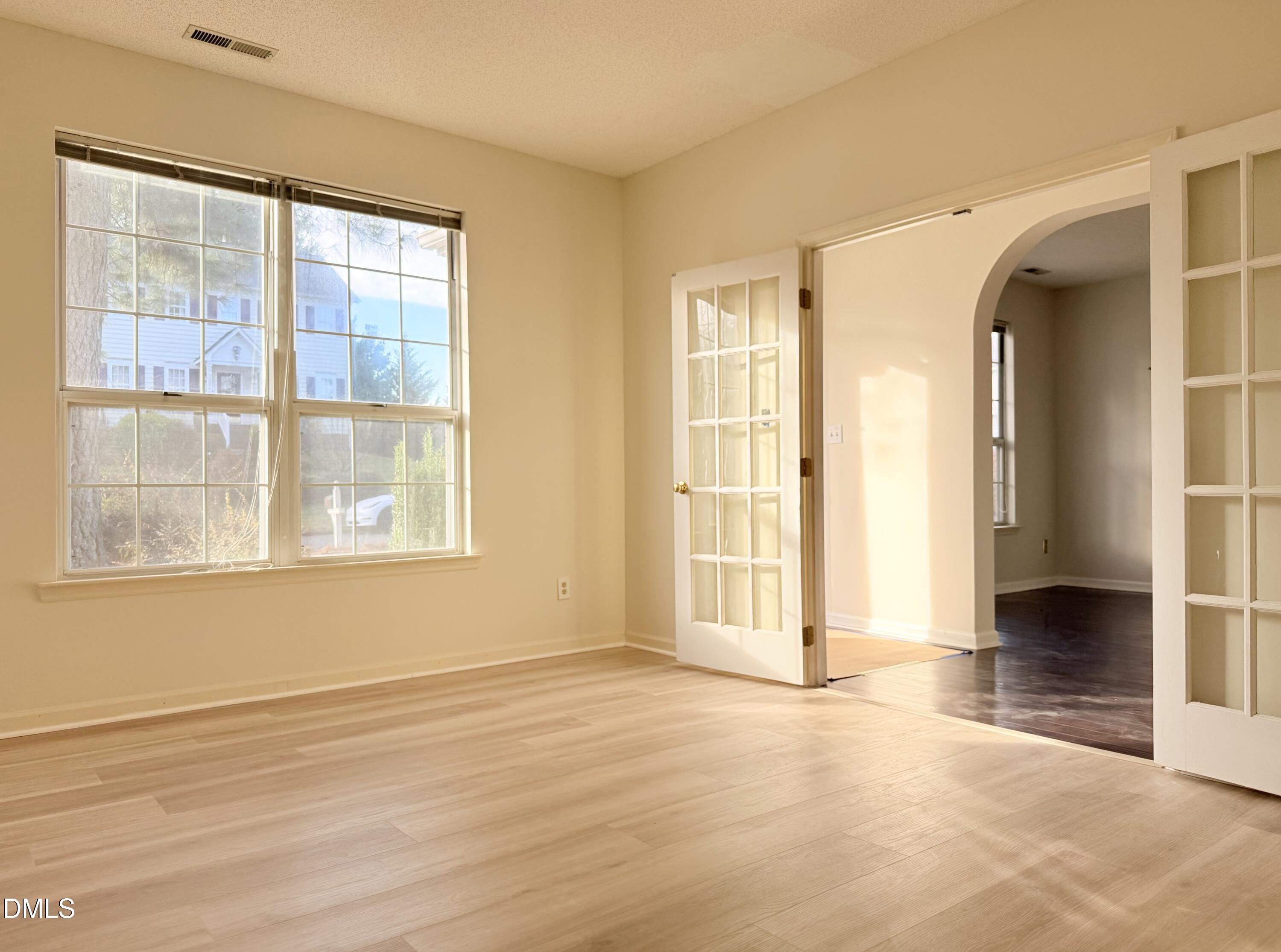 3610 Long Ridge Road Durham, NC 27703 - Photo 3 of 21 an empty room with wooden floor and windows