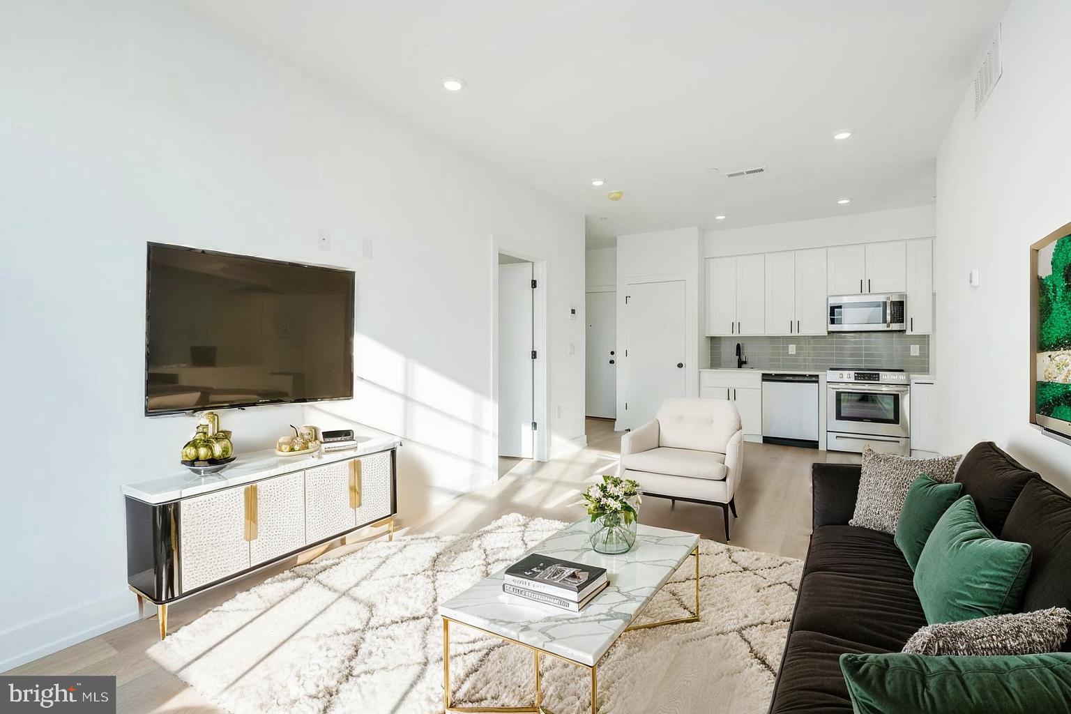 2002 Frankford Avenue, Unit 2F Philadelphia, PA 19125 - Photo 1 of 20 a living room with furniture and a flat screen tv