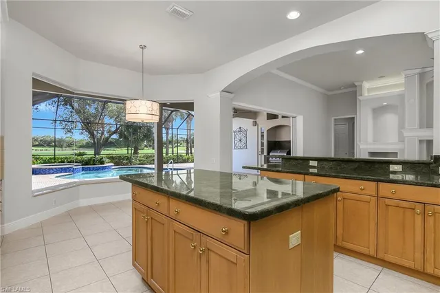 a kitchen with granite countertop a sink and a window