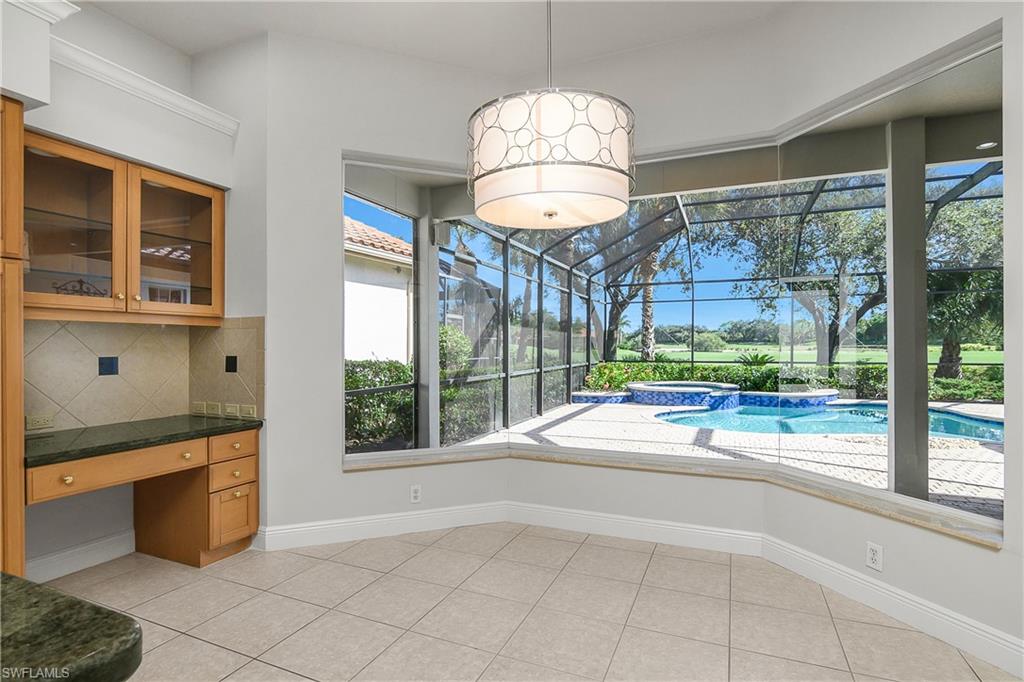 10160 Ginger Pointe Court Estero, FL 34135 - Photo 15 of 37 a open kitchen with granite countertop a stove and a large window