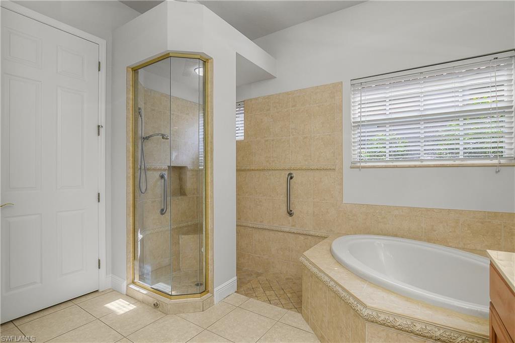 10160 Ginger Pointe Court Estero, FL 34135 - Photo 23 of 37 a bathroom with a bathtub and a shower