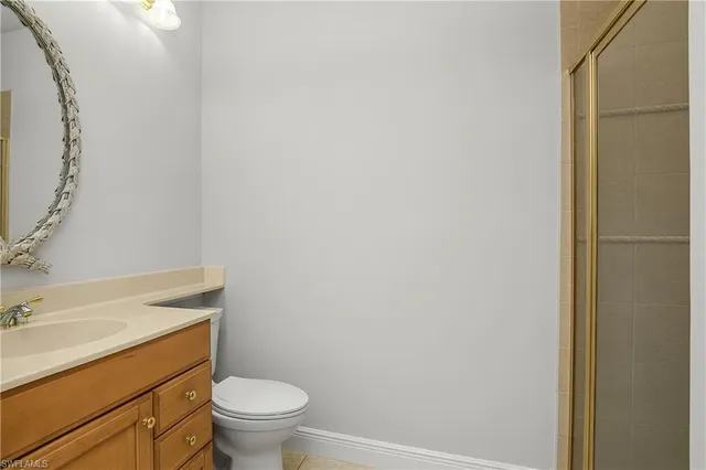 a bathroom with a granite countertop toilet and a sink
