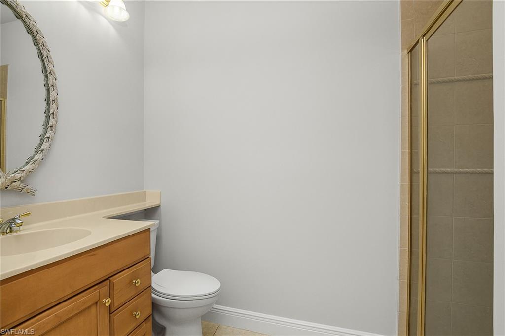 10160 Ginger Pointe Court Estero, FL 34135 - Photo 26 of 37 a bathroom with a granite countertop toilet and a sink