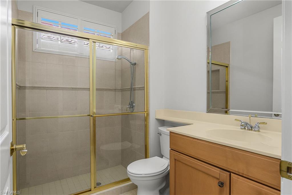 10160 Ginger Pointe Court Estero, FL 34135 - Photo 28 of 37 a bathroom with a granite countertop sink toilet and shower
