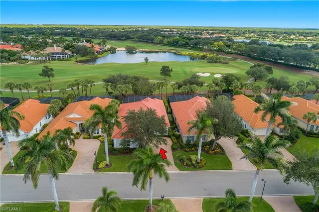 an aerial view of residential houses with outdoor space and lake view