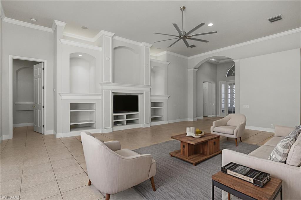 10160 Ginger Pointe Court Estero, FL 34135 - Photo 6 of 37 a living room with furniture ceiling fan and a fireplace