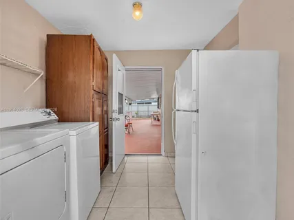 a view of a white house with a patio