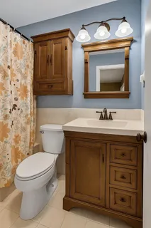 a bathroom with a toilet sink and mirror