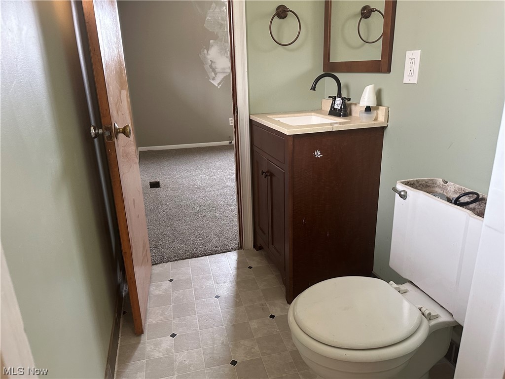 4410 Lane Road Painesville, OH 44077 - Photo 12 of 30 Bathroom with vanity, tile flooring, and toilet