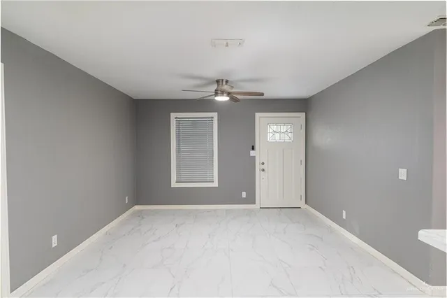 a view of an empty room with a window