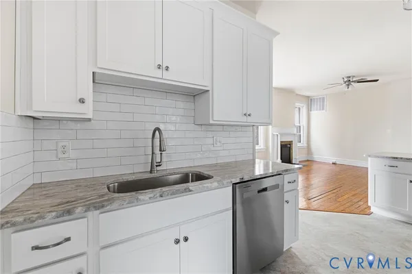 a kitchen with granite countertop a sink and cabinets