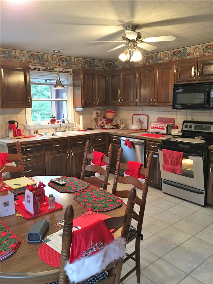 96 Swoope Road Swoope, VA 24479 - Photo 19 of 27 a kitchen with stainless steel appliances kitchen island granite countertop a dining table and chairs