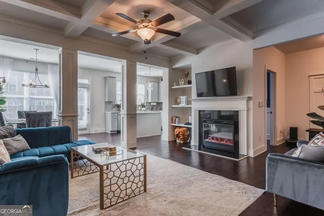 a living room with furniture a fireplace and a flat screen tv