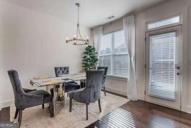 a view of a dining room with furniture window and wooden floor