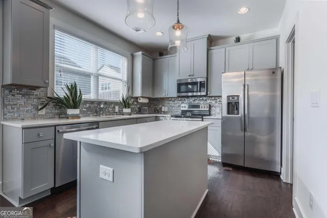 a kitchen with stainless steel appliances a sink stove and refrigerator