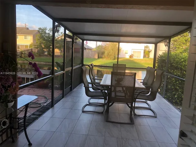 a view of a porch with furniture and a backyard