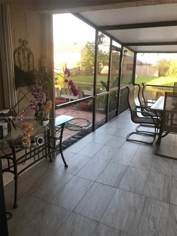 a living room with furniture and floor to ceiling window