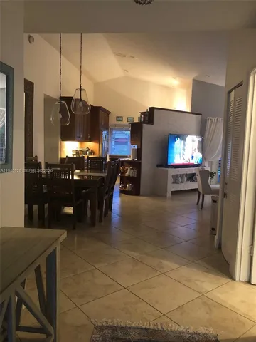 a view of a living room with furniture and a flat screen tv