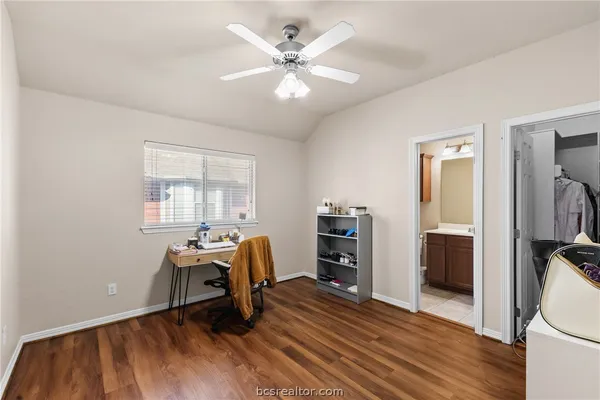 a bed room with a bed window and a flat tv screen