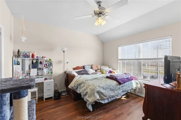 a bedroom with a bed a chandelier and a window
