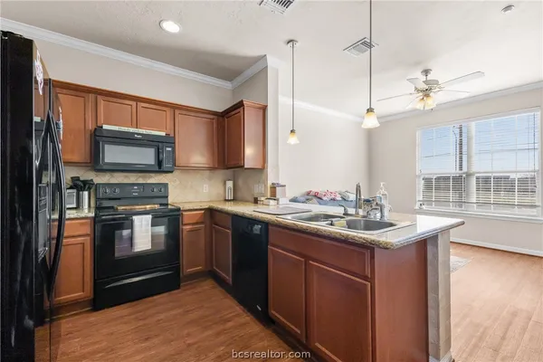 a kitchen with a sink stove and microwave