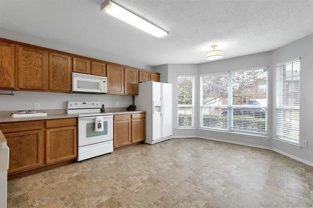 a kitchen with stainless steel appliances a refrigerator sink and cabinets